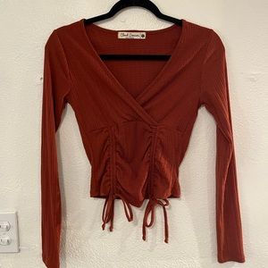 burnt orange lace up long sleeved top
